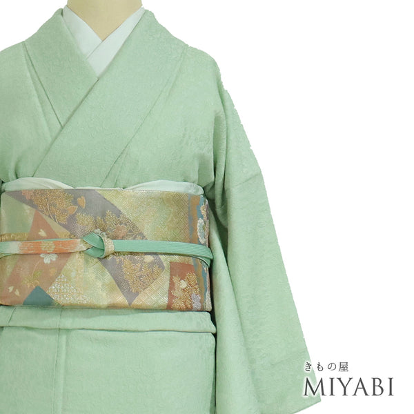 色無地 リサイクル 身丈160cm 裄64.4cm 袷 辻ヶ花地紋 草木染 グリーン Mサイズ セミフォーマル 一つ紋 しつけ糸 正絹 広衿 地紋あり Sランク